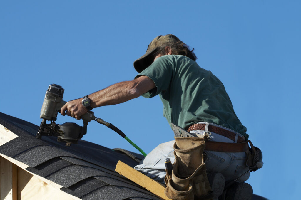 roofer working on roof replacement